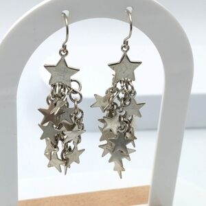 Dangle silver tone star earrings